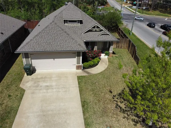 an aerial view of a house with swimming pool and patio