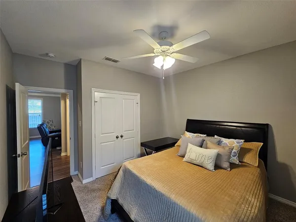 a bedroom with a large bed and a chandelier