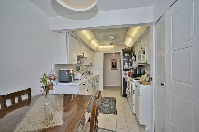 a kitchen with stainless steel appliances granite countertop a stove and cabinets