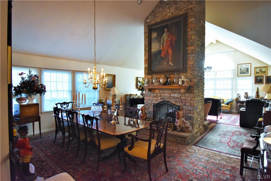 1039 Stone Stack Drive Bethlehem, PA 18015 - Photo 16 of 35 a living room with furniture a fireplace and a chandelier