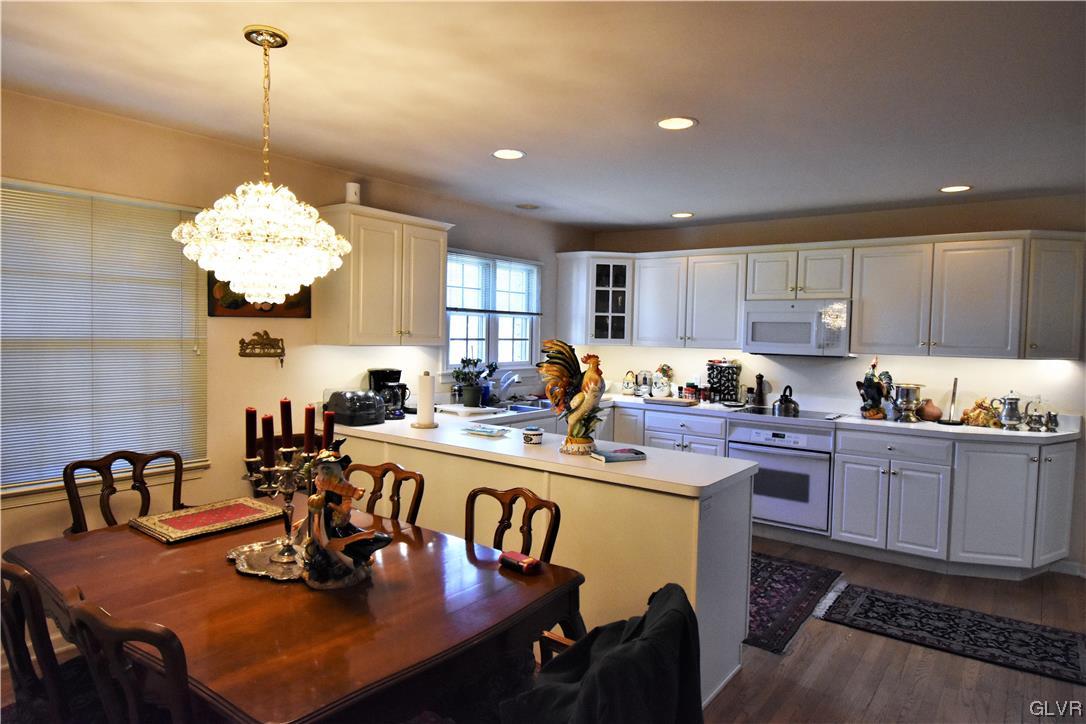 1039 Stone Stack Drive Bethlehem, PA 18015 - Photo 18 of 35 a kitchen with a dining table chairs a sink dishwasher a dining table and chairs