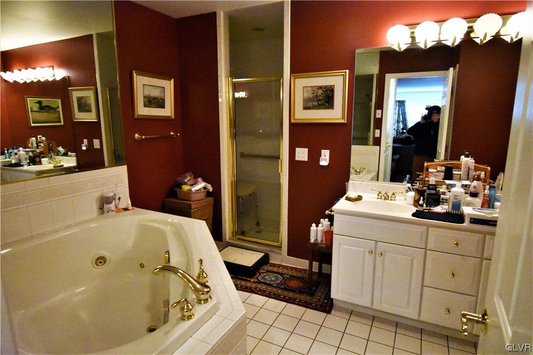 1039 Stone Stack Drive Bethlehem, PA 18015 - Photo 23 of 35 a bathroom with a tub sink and mirror