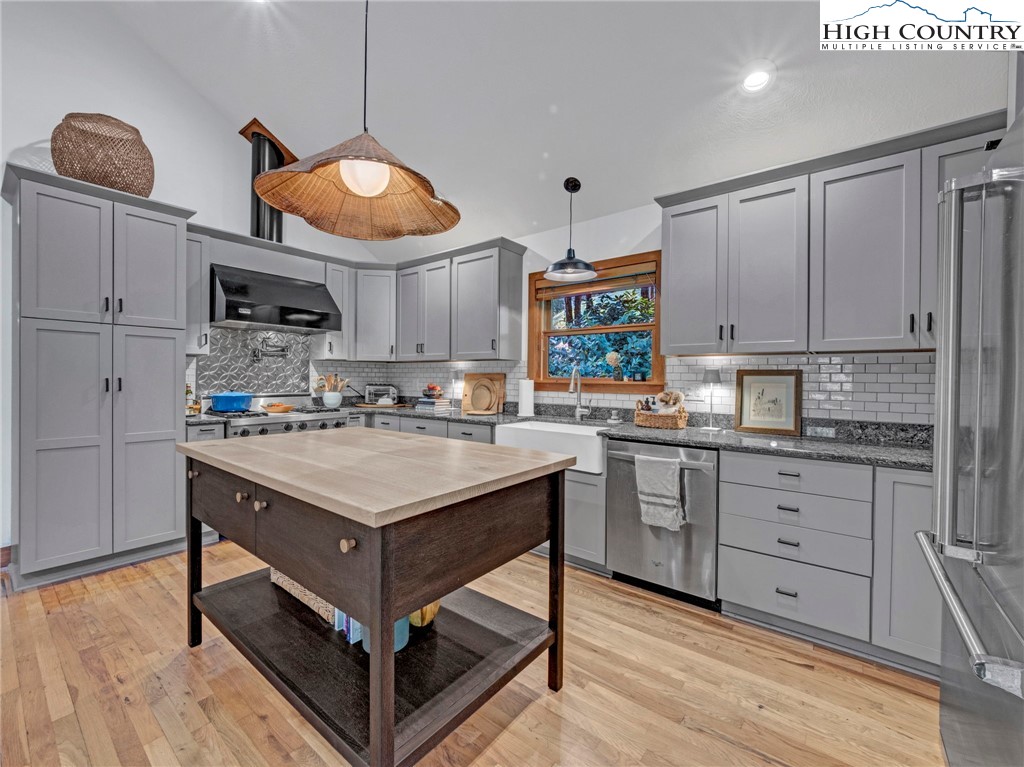 165-201 All Hallows Road Boone, NC 28607 - Photo 13 of 46 a kitchen with stainless steel appliances granite countertop a stove a sink dishwasher and a microwave oven with white cabinets