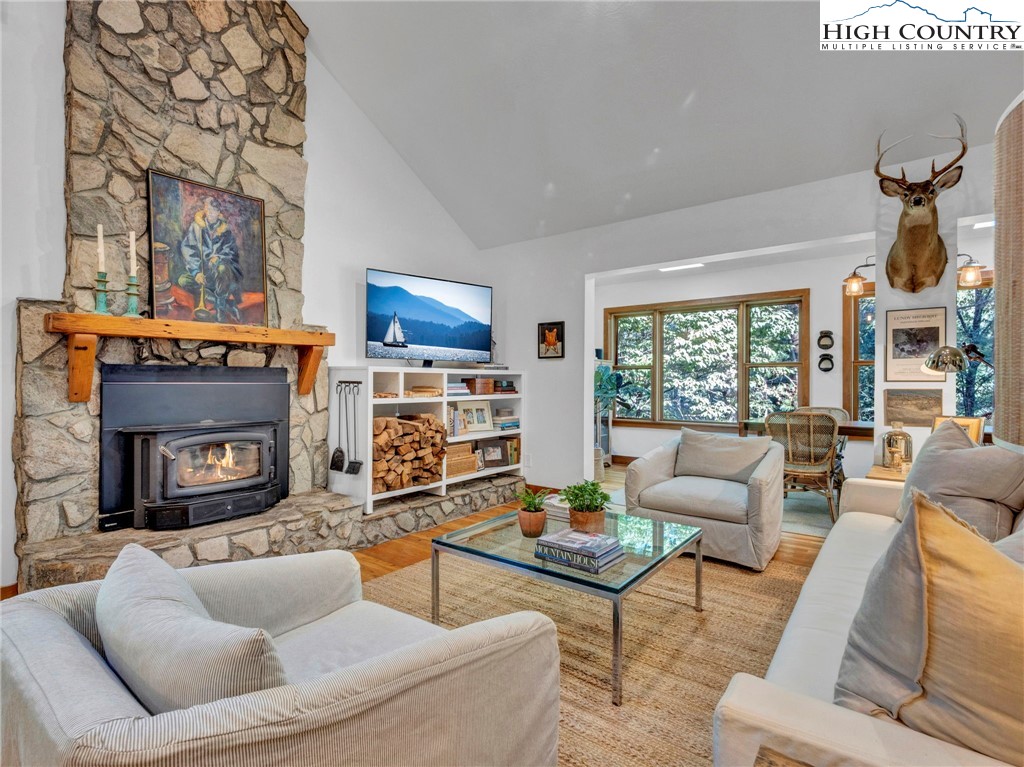 165-201 All Hallows Road Boone, NC 28607 - Photo 2 of 46 a living room with furniture a fireplace and a large window