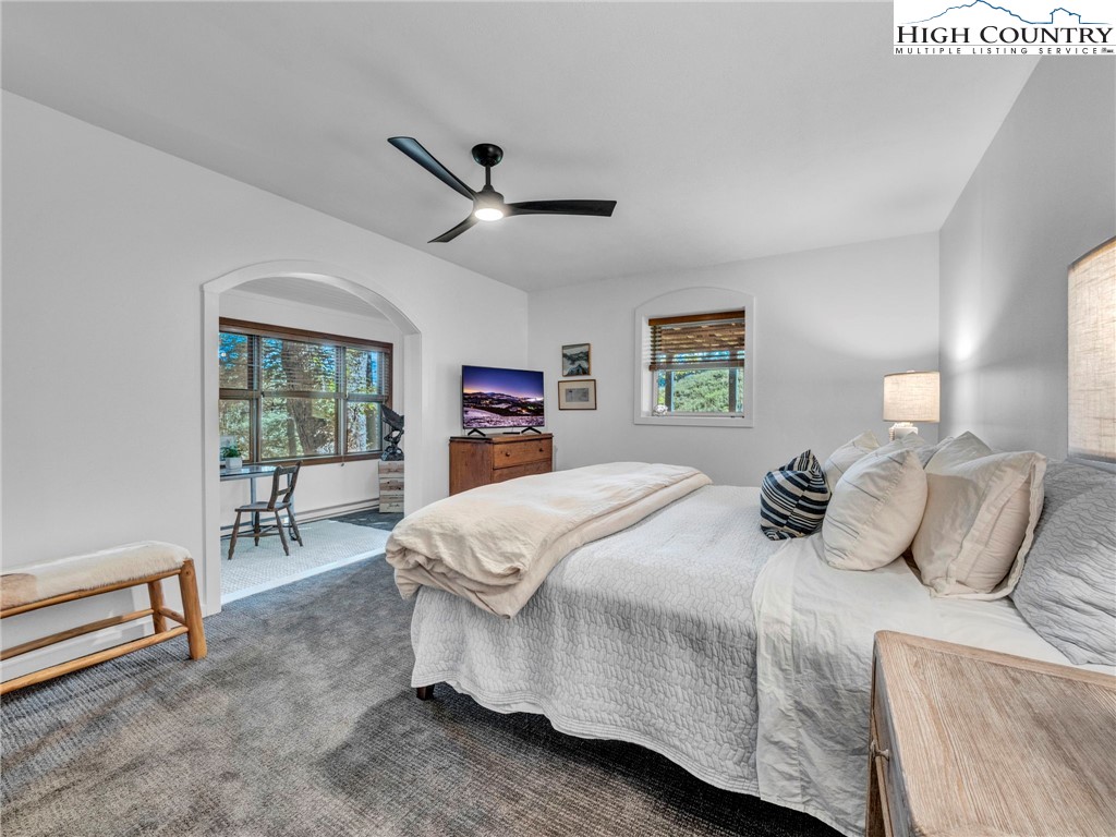 165-201 All Hallows Road Boone, NC 28607 - Photo 29 of 46 a bedroom with a bed and a chandelier