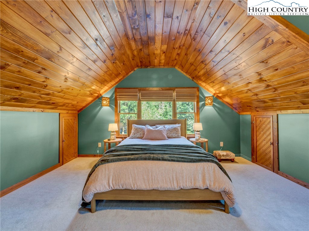165-201 All Hallows Road Boone, NC 28607 - Photo 41 of 46 a bedroom with a bed and a outer view