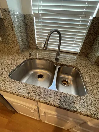 a bathroom with a sink and a window
