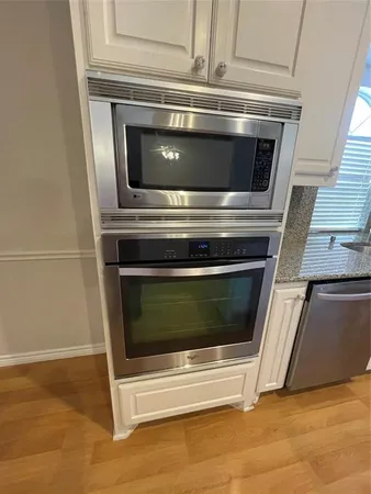 a stove top oven sitting inside of a kitchen