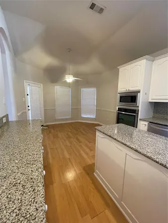 a bathroom with a granite countertop sink a toilet and granite