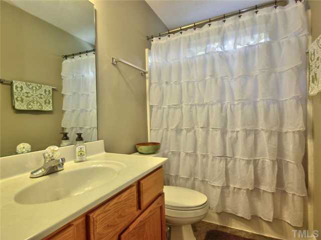 4309 Pillory Place Raleigh, NC 27616 - Photo 17 of 23 a bathroom with a sink and a mirror