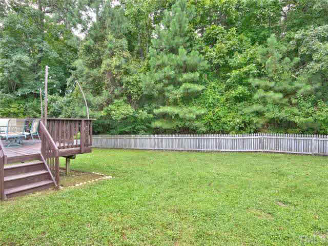 4309 Pillory Place Raleigh, NC 27616 - Photo 21 of 23 a view of a backyard with wooden fence and a bench