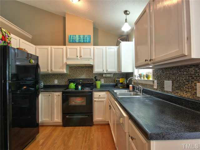 4309 Pillory Place Raleigh, NC 27616 - Photo 7 of 23 a kitchen with stainless steel appliances granite countertop a refrigerator a stove and a sink