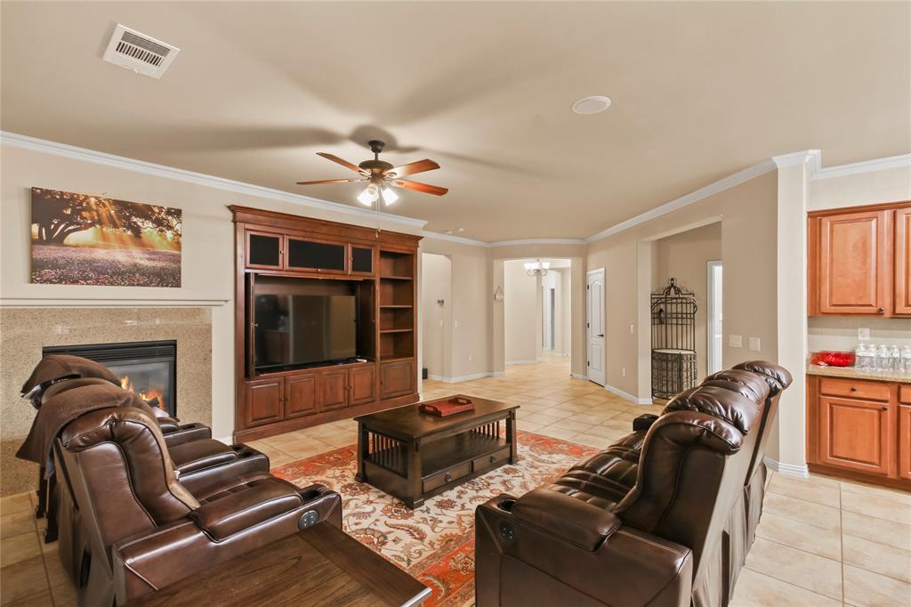 9116 Perimeter Street Denton, TX 76207 - Photo 13 of 26 a living room with furniture ceiling fan and a fireplace