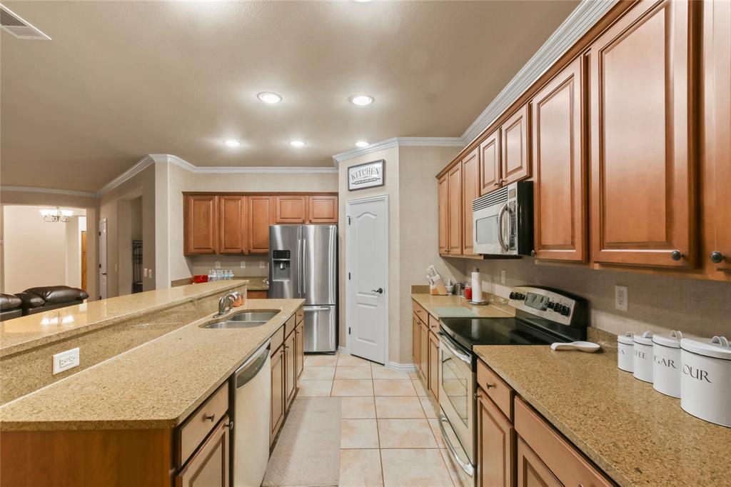9116 Perimeter Street Denton, TX 76207 - Photo 14 of 26 a kitchen with a sink stove and refrigerator