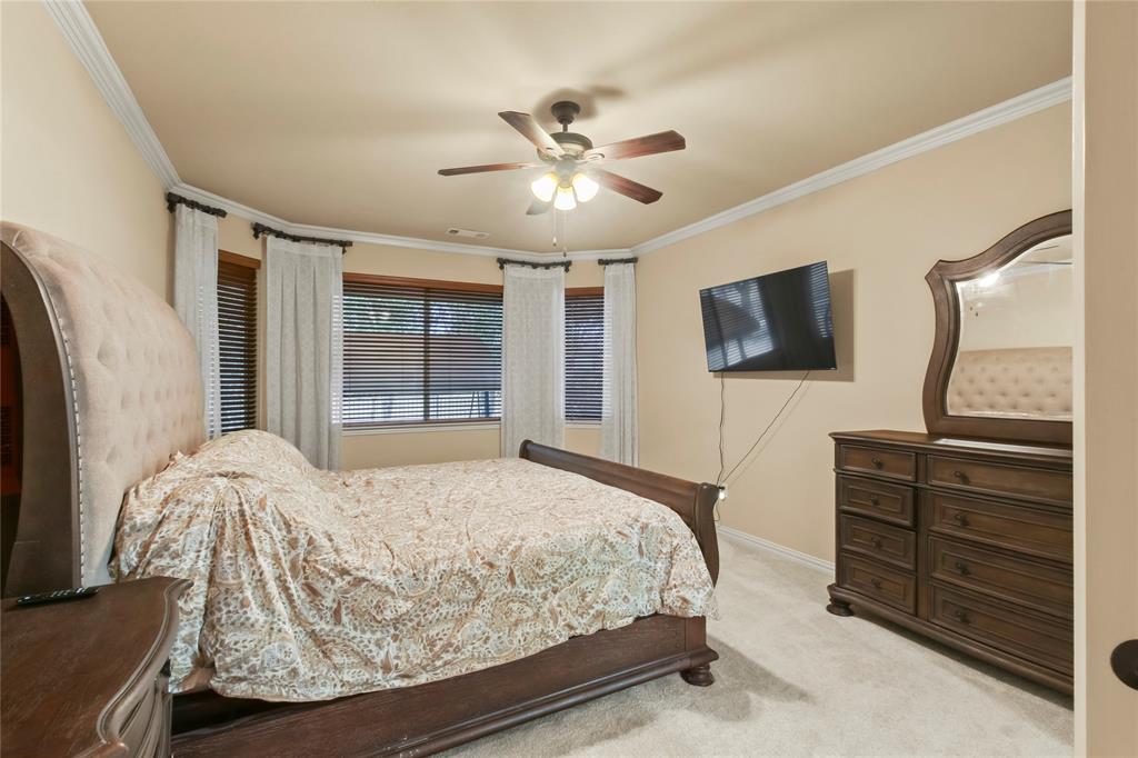 9116 Perimeter Street Denton, TX 76207 - Photo 19 of 26 a bedroom with a bed and a flat screen tv