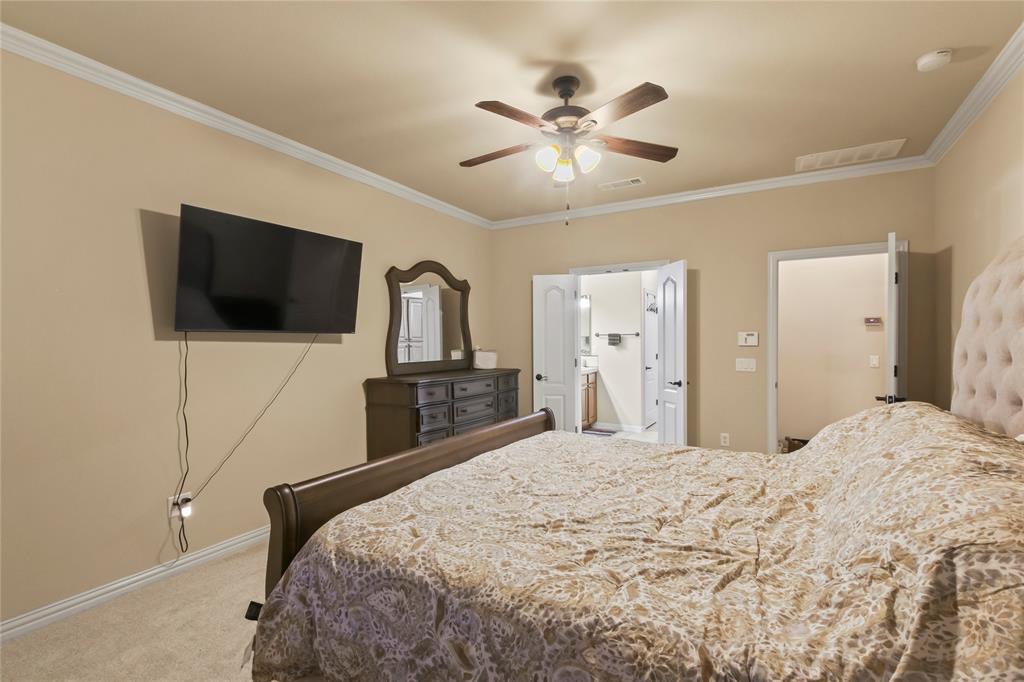 9116 Perimeter Street Denton, TX 76207 - Photo 20 of 26 a bedroom with a bed and a flat screen tv