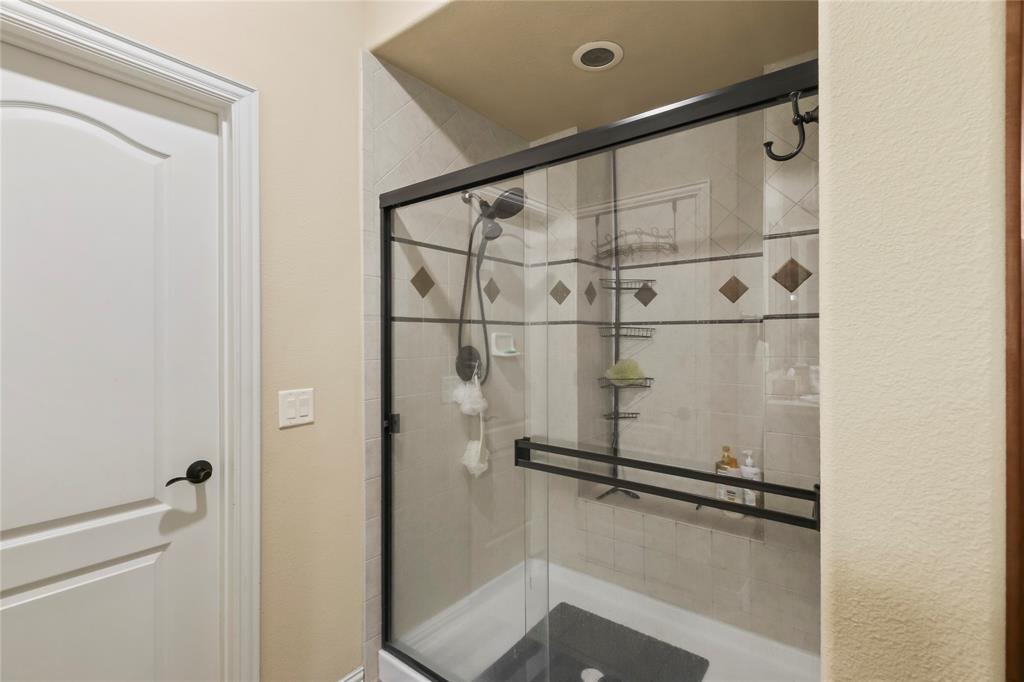 9116 Perimeter Street Denton, TX 76207 - Photo 22 of 26 a bathroom with a shower and a mirror