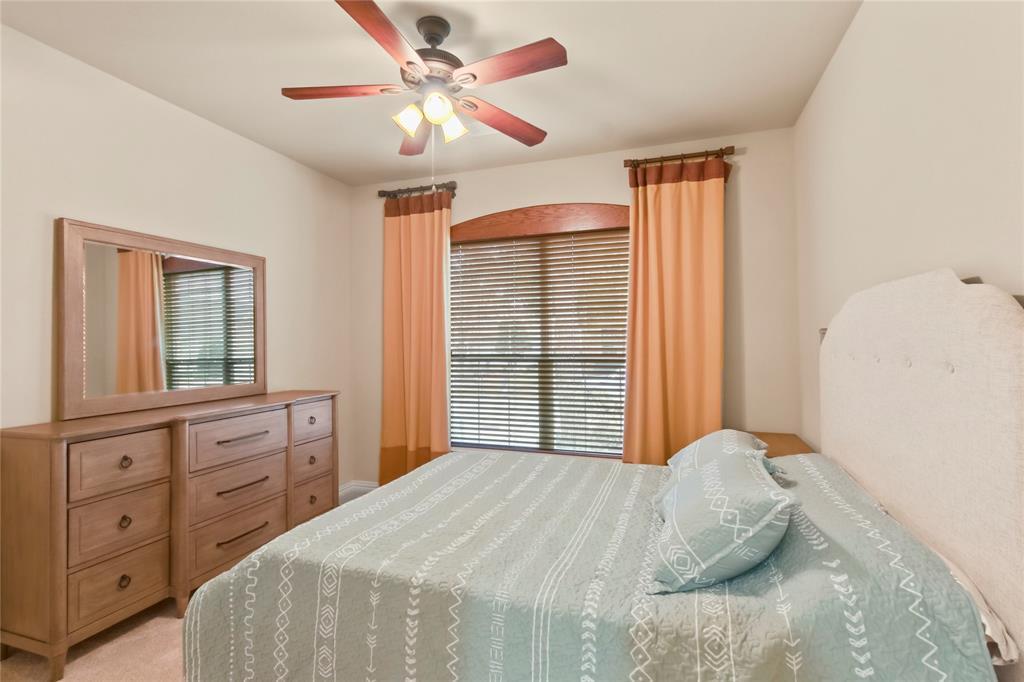 9116 Perimeter Street Denton, TX 76207 - Photo 3 of 26 a bedroom with a large bed and a chandelier