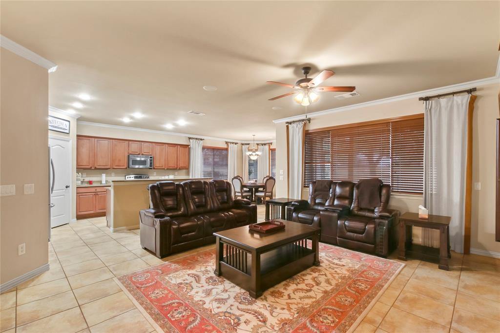 9116 Perimeter Street Denton, TX 76207 - Photo 6 of 26 a living room with furniture kitchen view and a large window