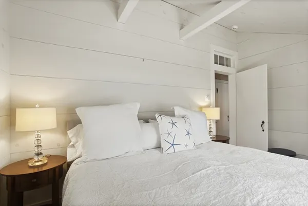 a bedroom with a bed and a lamp
