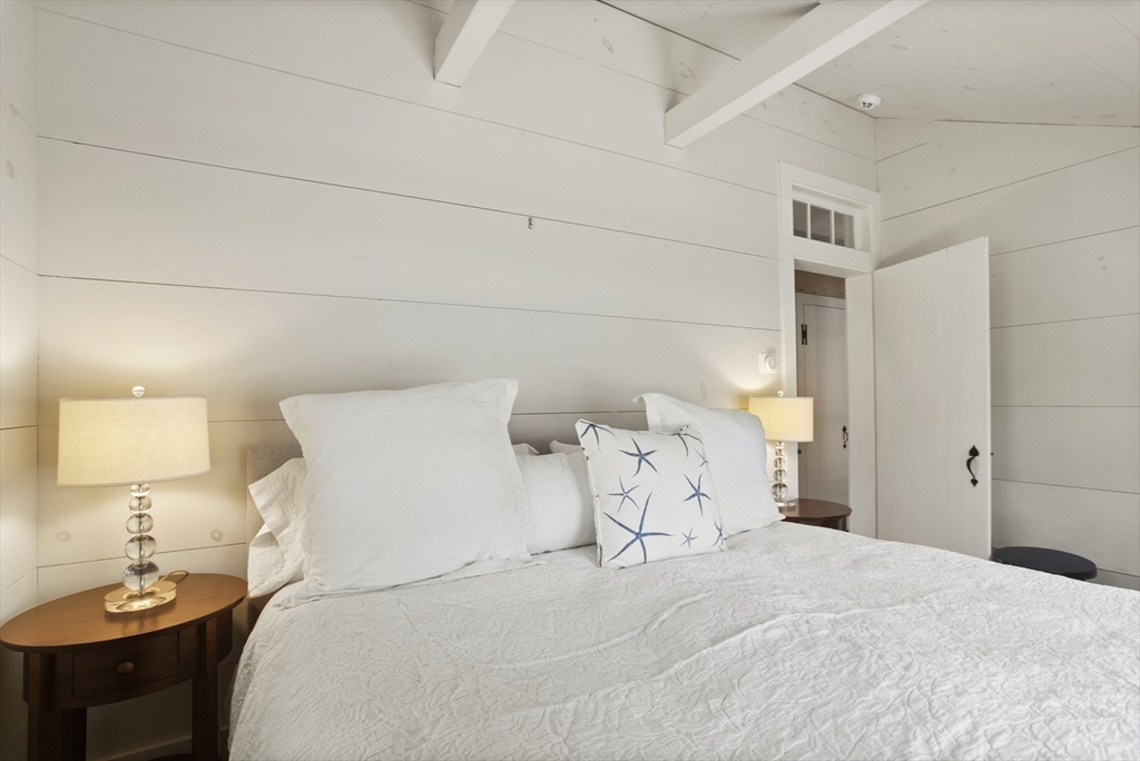 9 Lily Street Nantucket, MA 02554 - Photo 12 of 17 a bedroom with a bed and a lamp