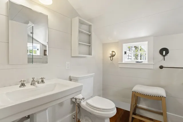 a bathroom with a sink toilet and a mirror