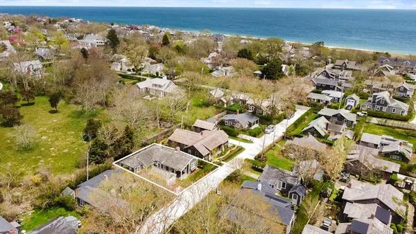 an aerial view of residential building with parking
