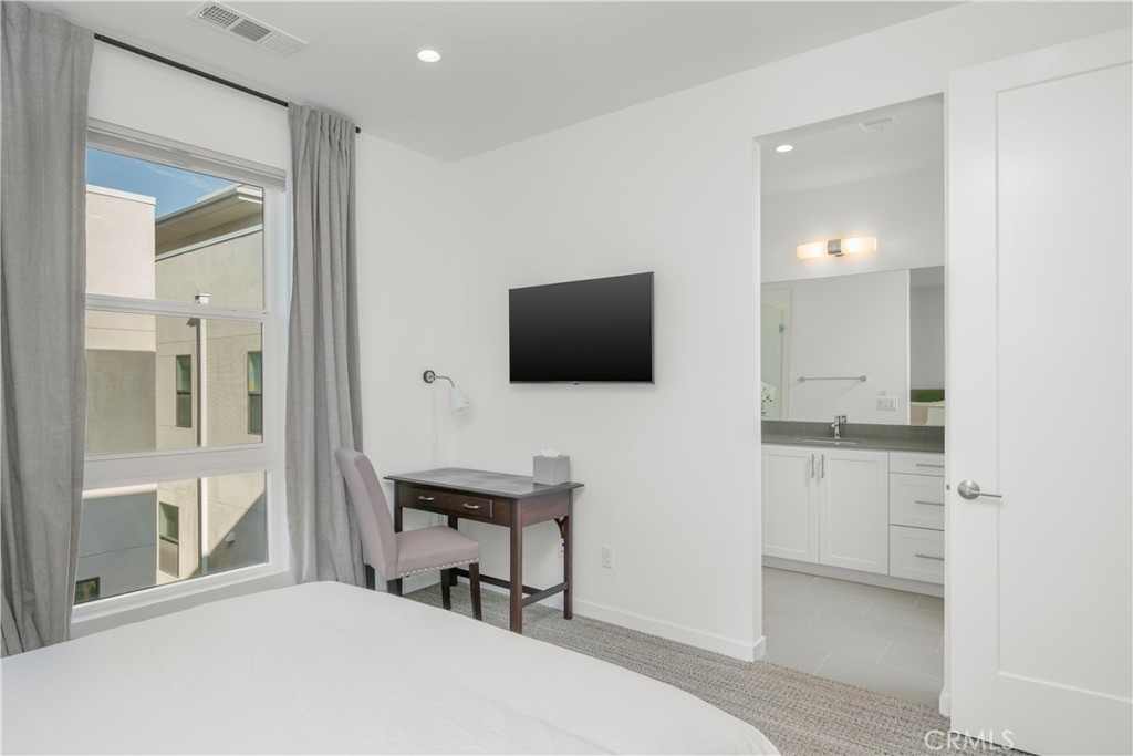 637 Cardiff Reef Costa Mesa, CA 92627 - Photo 20 of 27 a bedroom with a bed and a flat screen tv