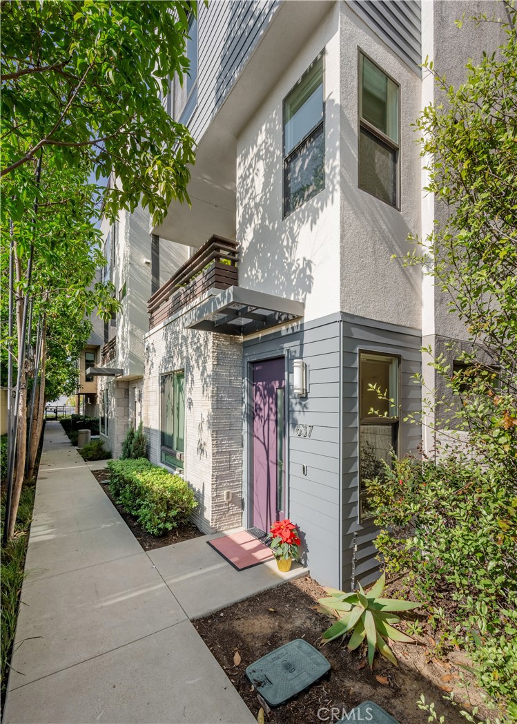 637 Cardiff Reef Costa Mesa, CA 92627 - Photo 2 of 27 a front view of a house with garden