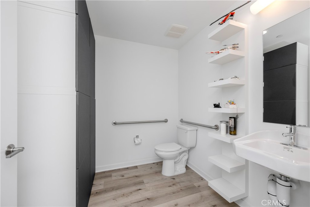 637 Cardiff Reef Costa Mesa, CA 92627 - Photo 6 of 27 a bathroom with a sink toilet a mirror and shower