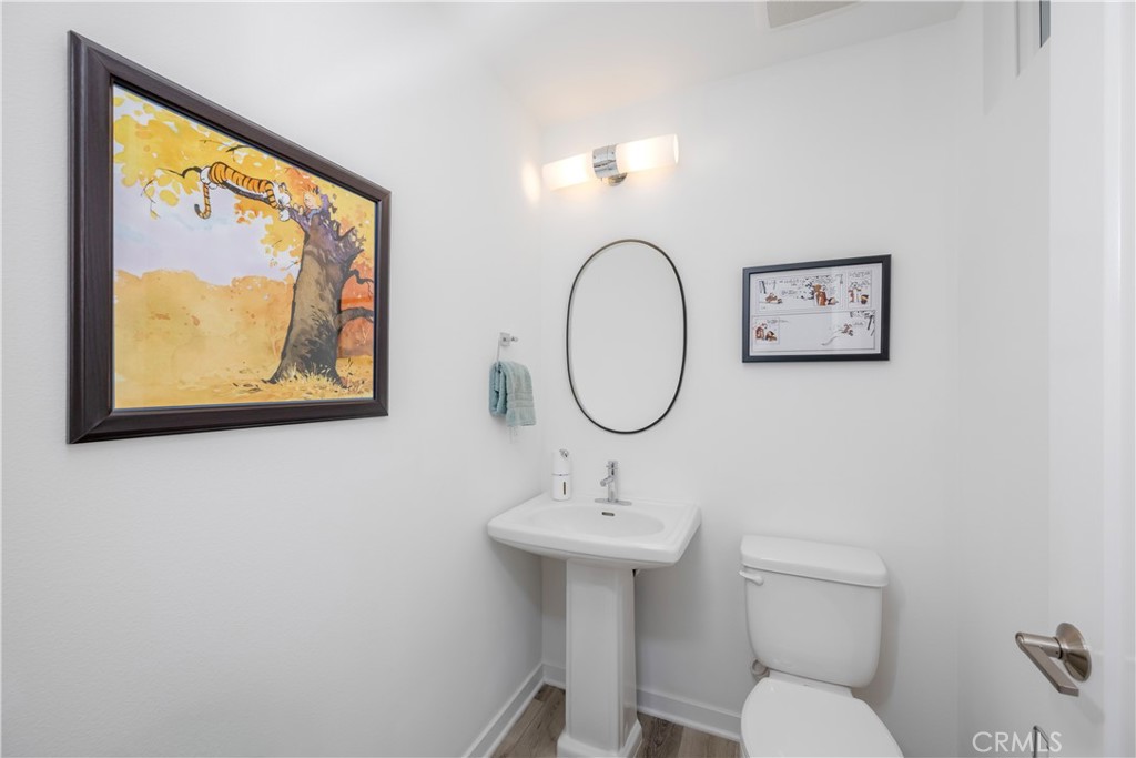 637 Cardiff Reef Costa Mesa, CA 92627 - Photo 7 of 27 a bathroom with a toilet a sink and mirror