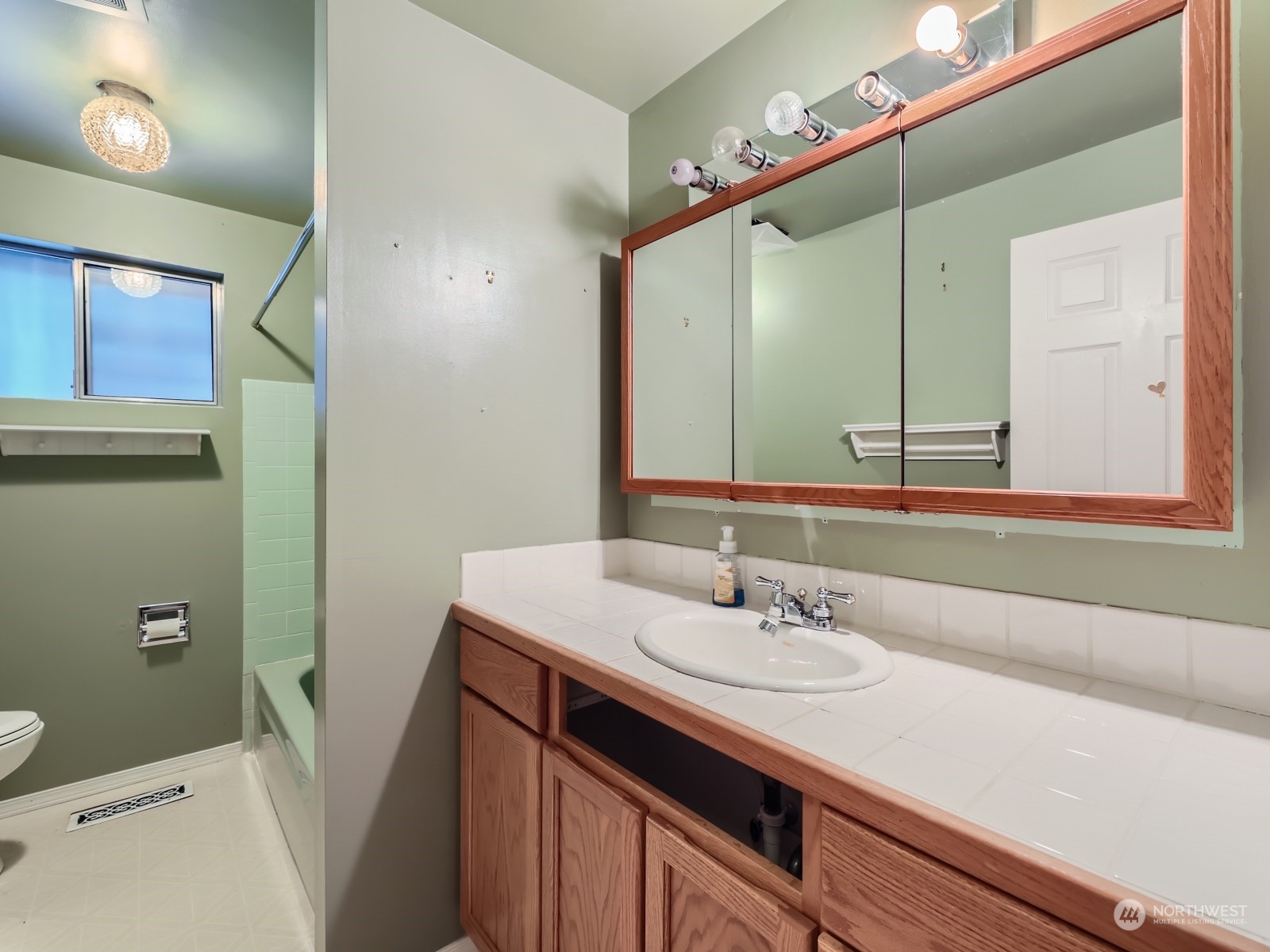 2730 Forest View Drive Everett, WA 98203 - Photo 15 of 28 a bathroom with a sink a vanity and a mirror