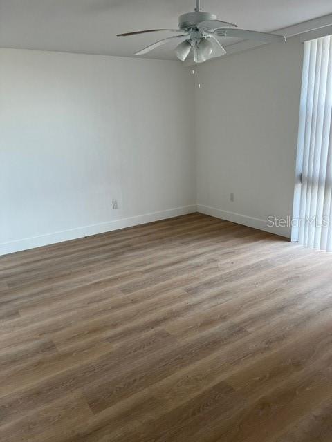 16308 Gulf Boulevard, Unit 103 Redington Beach, FL 33708 - Photo 11 of 23 a view of a room with wooden floor and fan