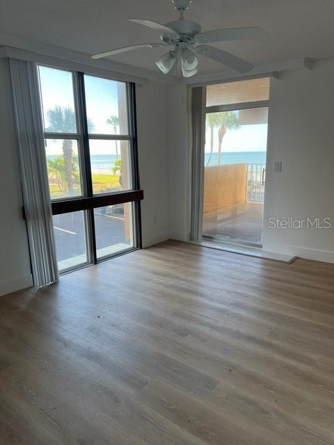 16308 Gulf Boulevard, Unit 103 Redington Beach, FL 33708 - Photo 12 of 23 an empty room with wooden floor and a window