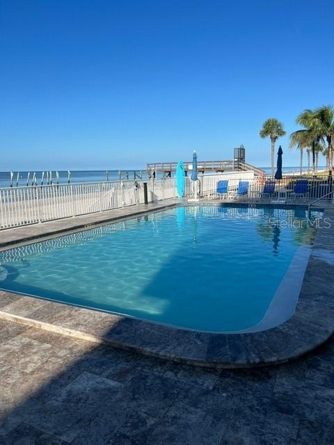 16308 Gulf Boulevard, Unit 103 Redington Beach, FL 33708 - Photo 21 of 23 a view of a swimming pool with an outdoor seating