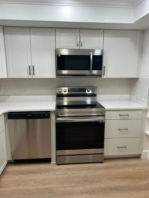 16308 Gulf Boulevard, Unit 103 Redington Beach, FL 33708 - Photo 3 of 23 a stove top oven sitting inside of a kitchen