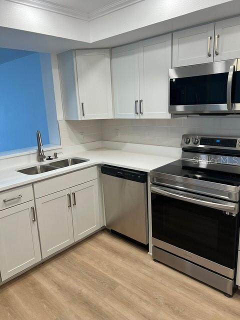 16308 Gulf Boulevard, Unit 103 Redington Beach, FL 33708 - Photo 5 of 23 a kitchen with a sink stove and microwave