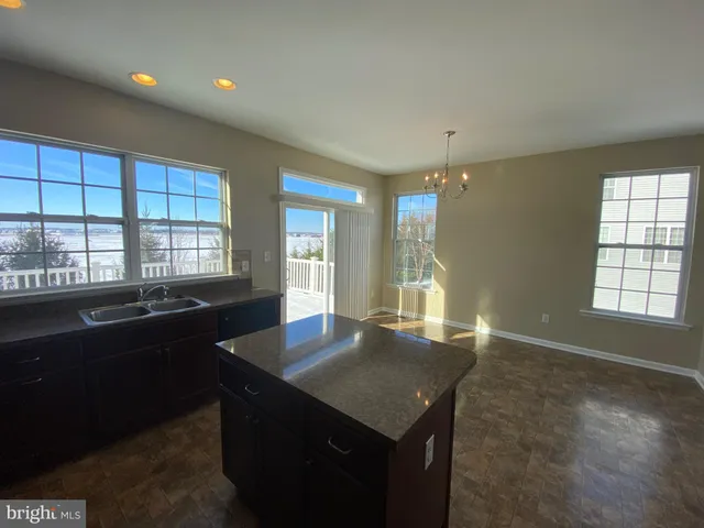 a kitchen with granite countertop a stove and a sink