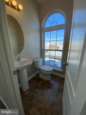 a bathroom with a toilet sink and window