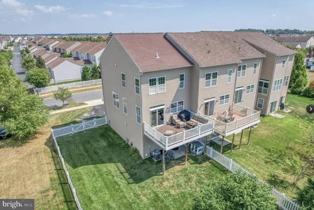 an aerial view of a house with a yard table and chairs