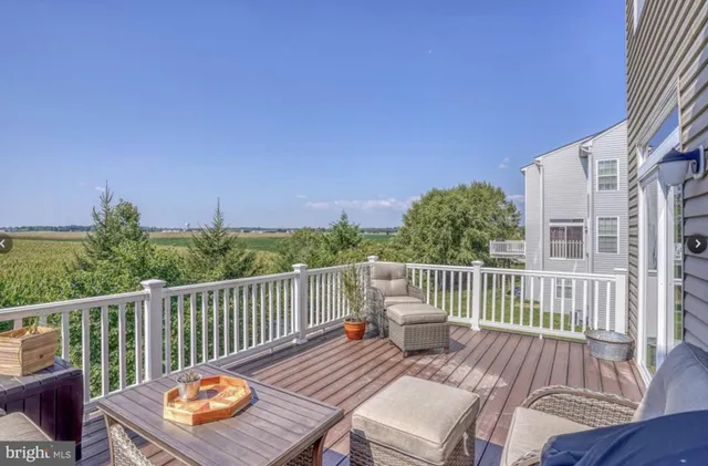 a view of balcony with wooden floor and outdoor seating