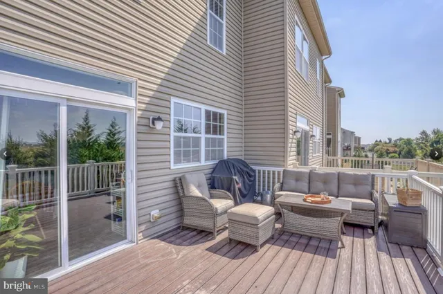 a balcony with wooden floor and furniture