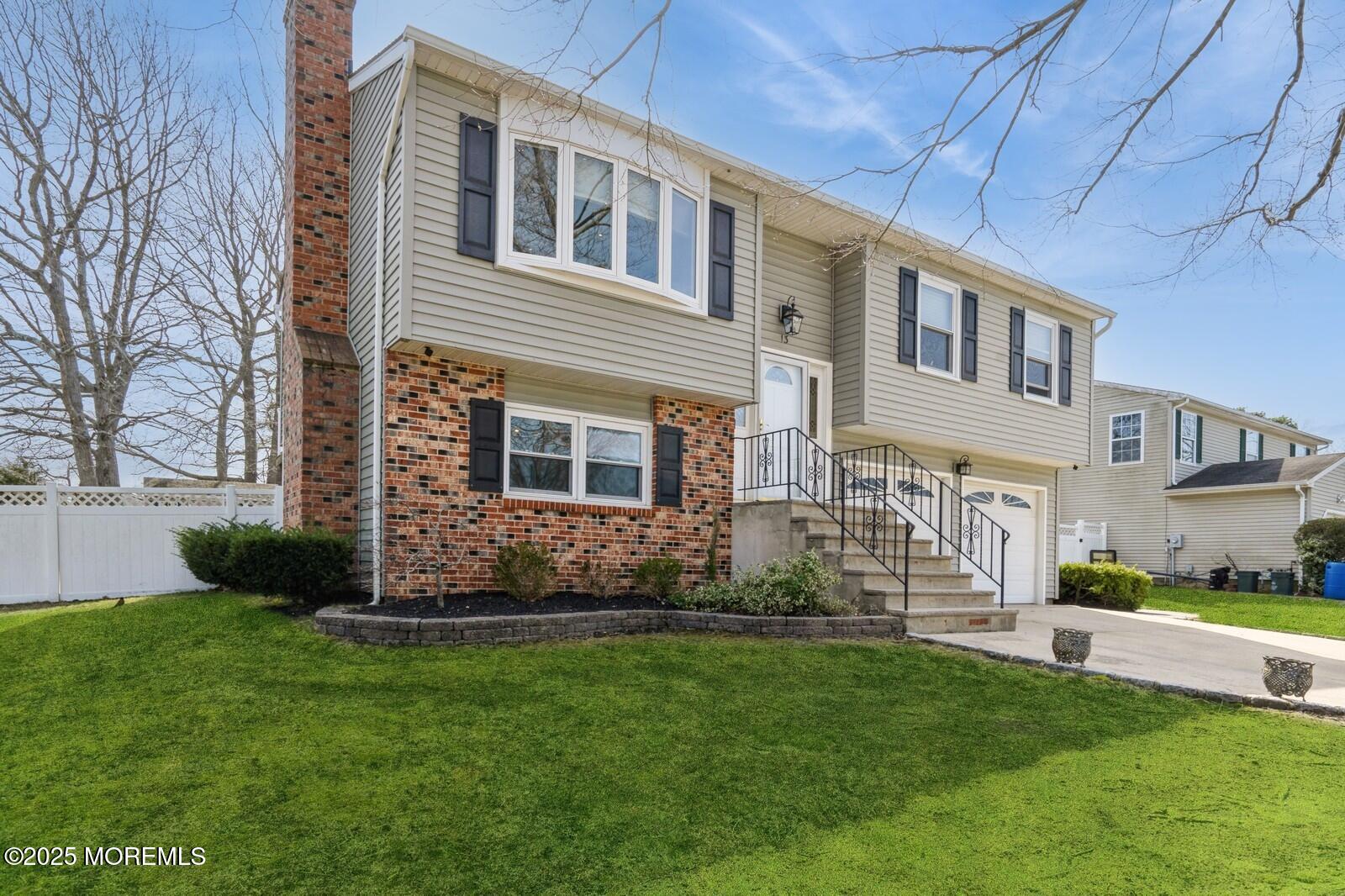a front view of a house with a garden and plants