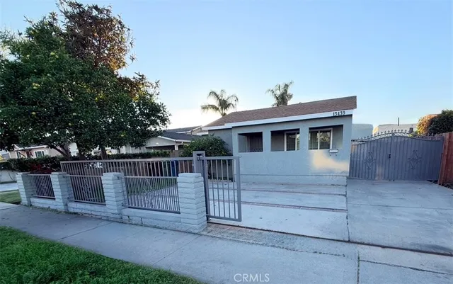 a view of a house with a wooden fence