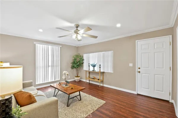 a living room with furniture and wooden floor