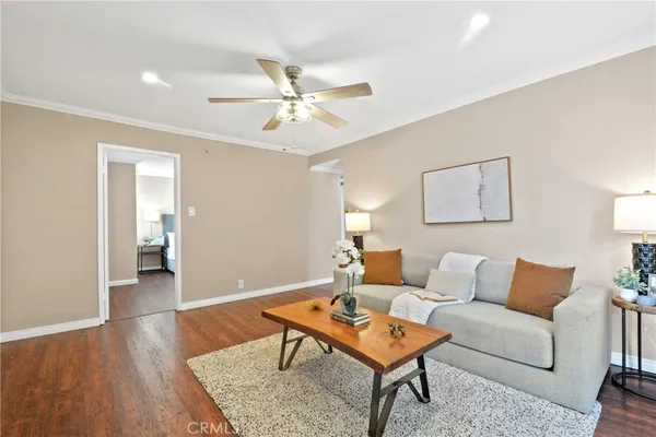 a living room with furniture and a wooden floor
