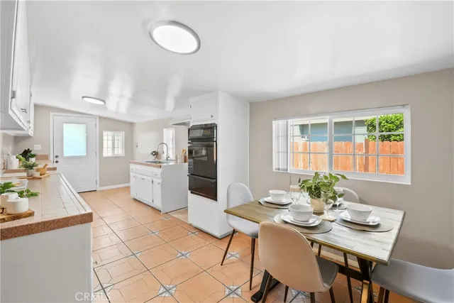 a kitchen with a table and chairs in it