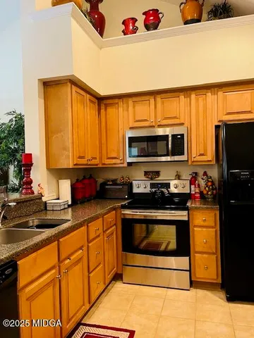 a kitchen with granite countertop a sink stainless steel appliances and cabinets