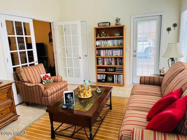 a living room with furniture and a book shelf