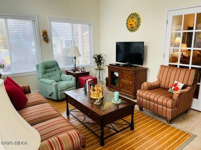 a living room with furniture and a flat screen tv